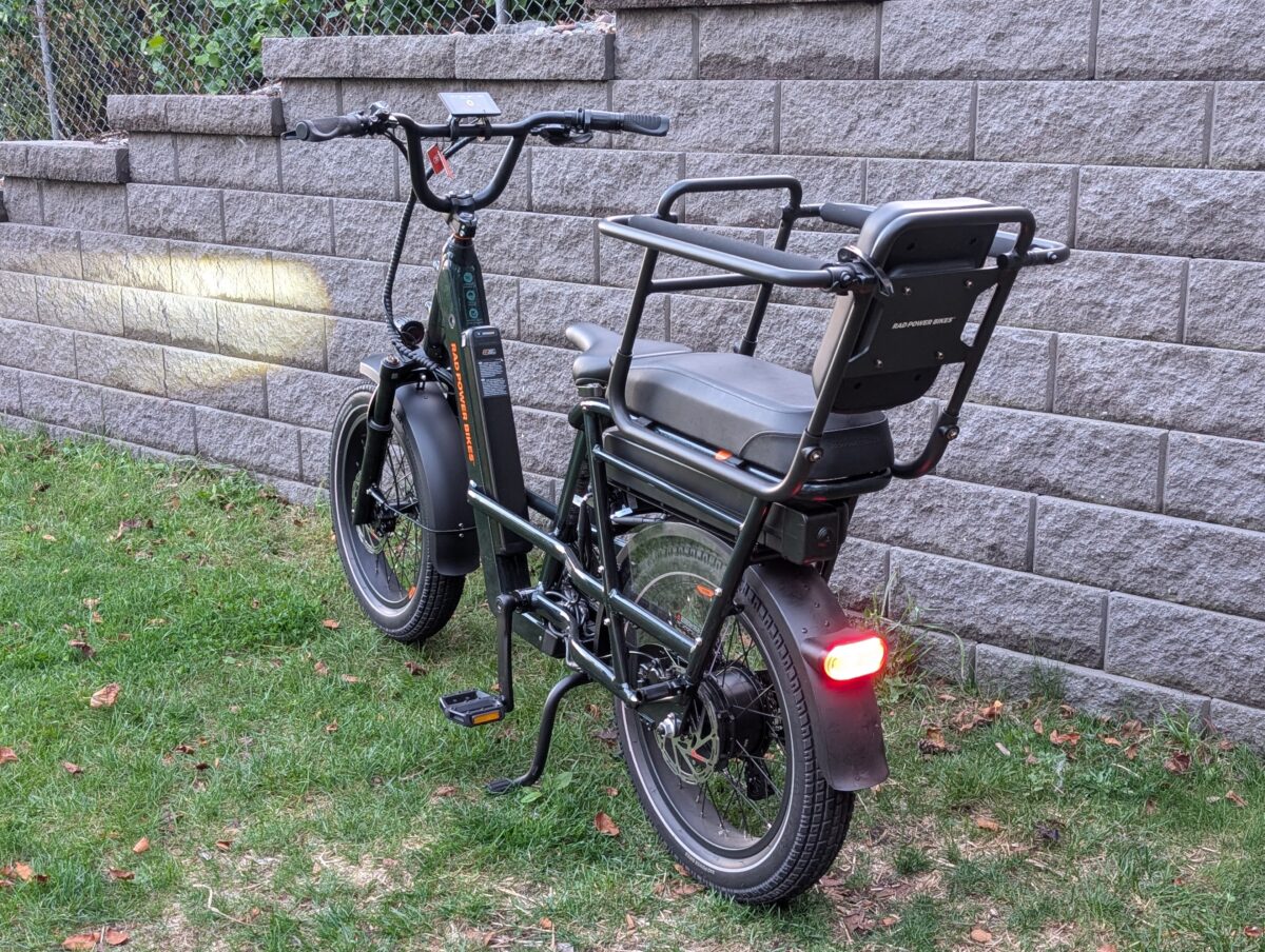 Rear view of the Rad Power Bikes RadRunner Max, showing the integrated rear rack, taillight, turn signals, and 750W motor.