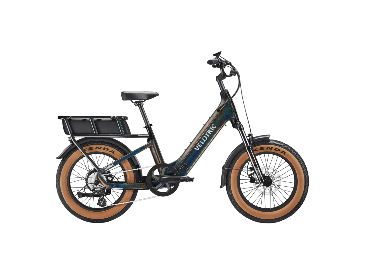Velotric electric bike in Iridescent finish with tan-sidewall tires and rear cargo rack, shown in profile view