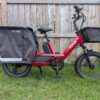 Drive-side profile of the red Radio Flyer Flyer Loop cargo ebike with front basket and rear cargo bag