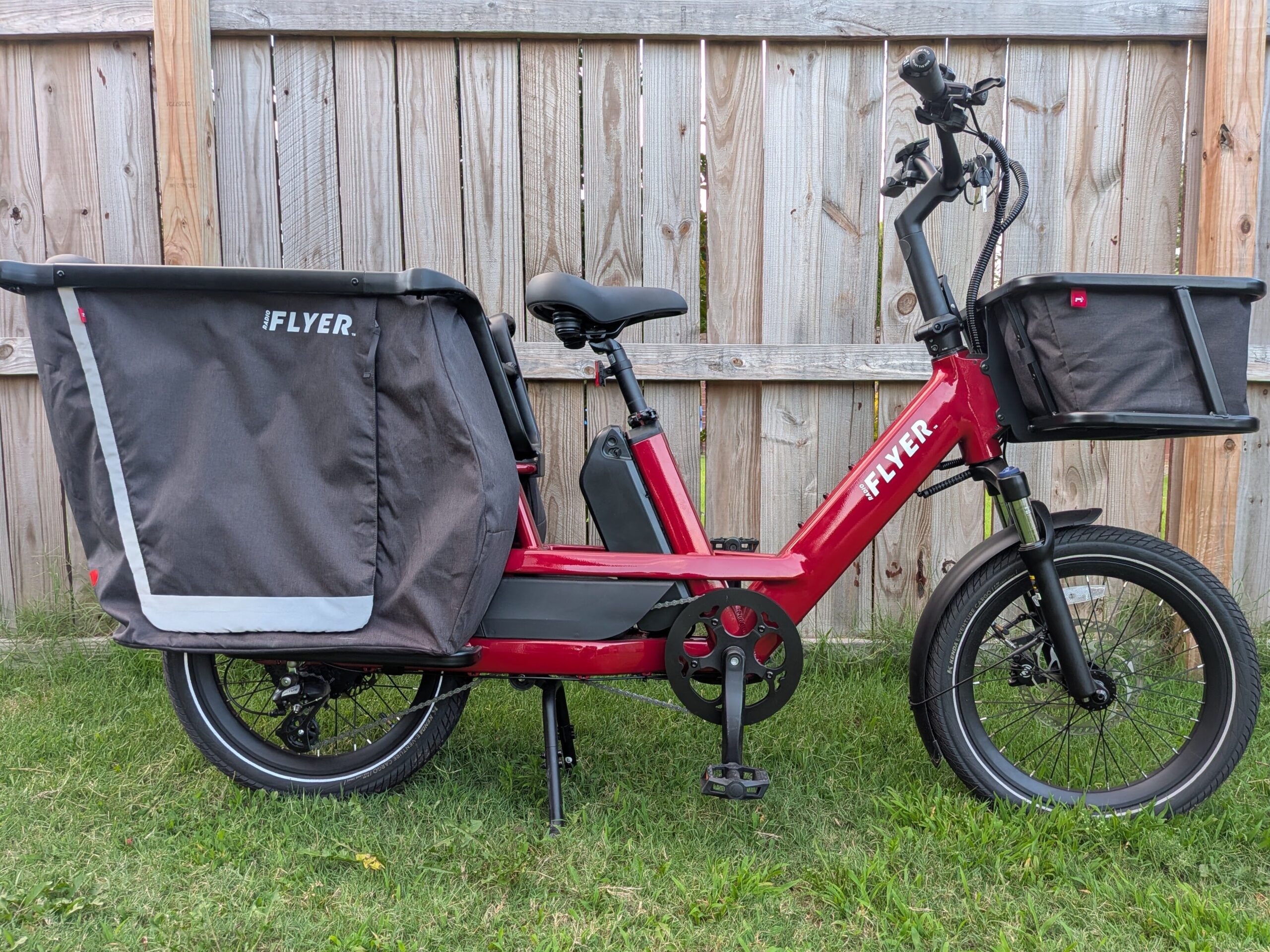 Drive-side profile of the red Radio Flyer Flyer Loop cargo ebike with front basket and rear cargo bag