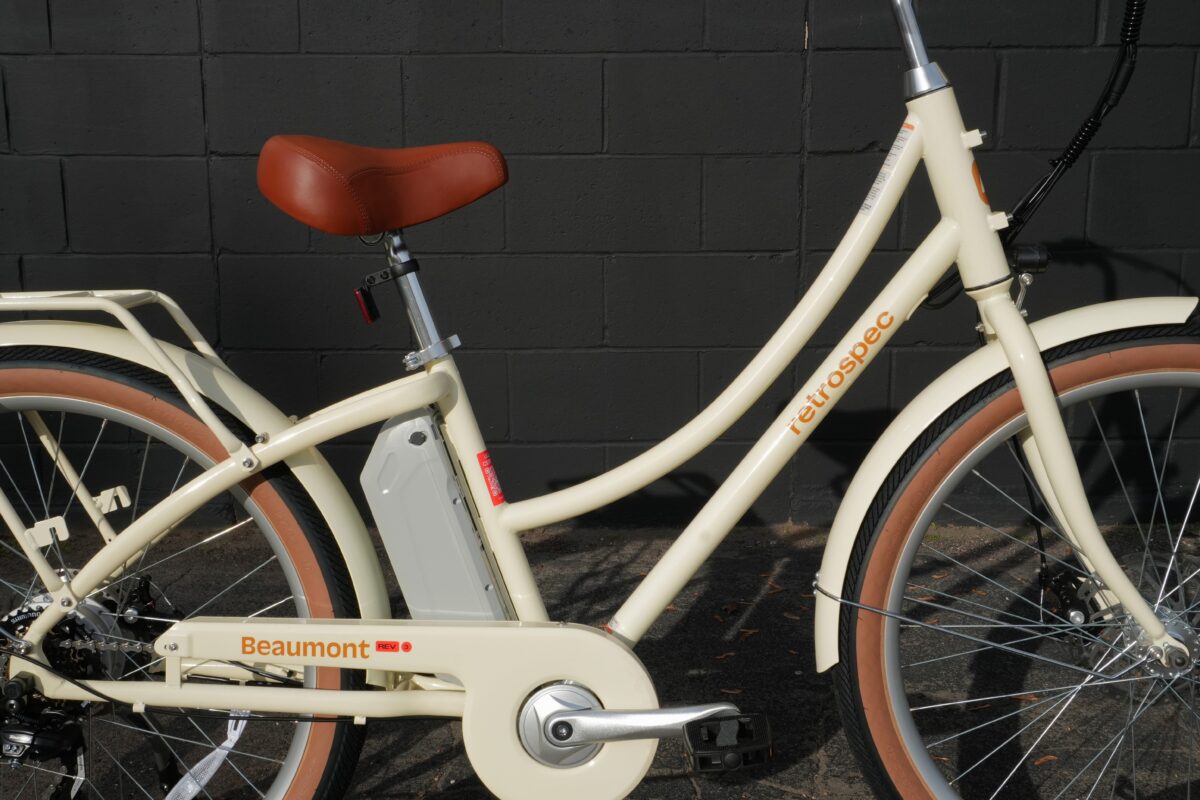 Beaumont Rev 3 step-thru frame showing battery, seat stay, and Retrospec branding in Eggshell