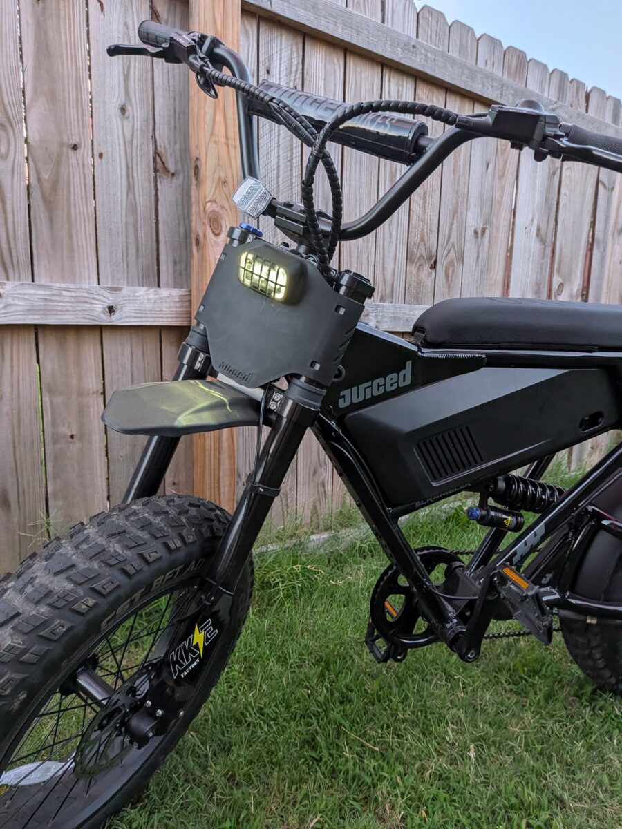 Front three-quarter view with the headlight on on the Juiced Scrambler Full Suspension