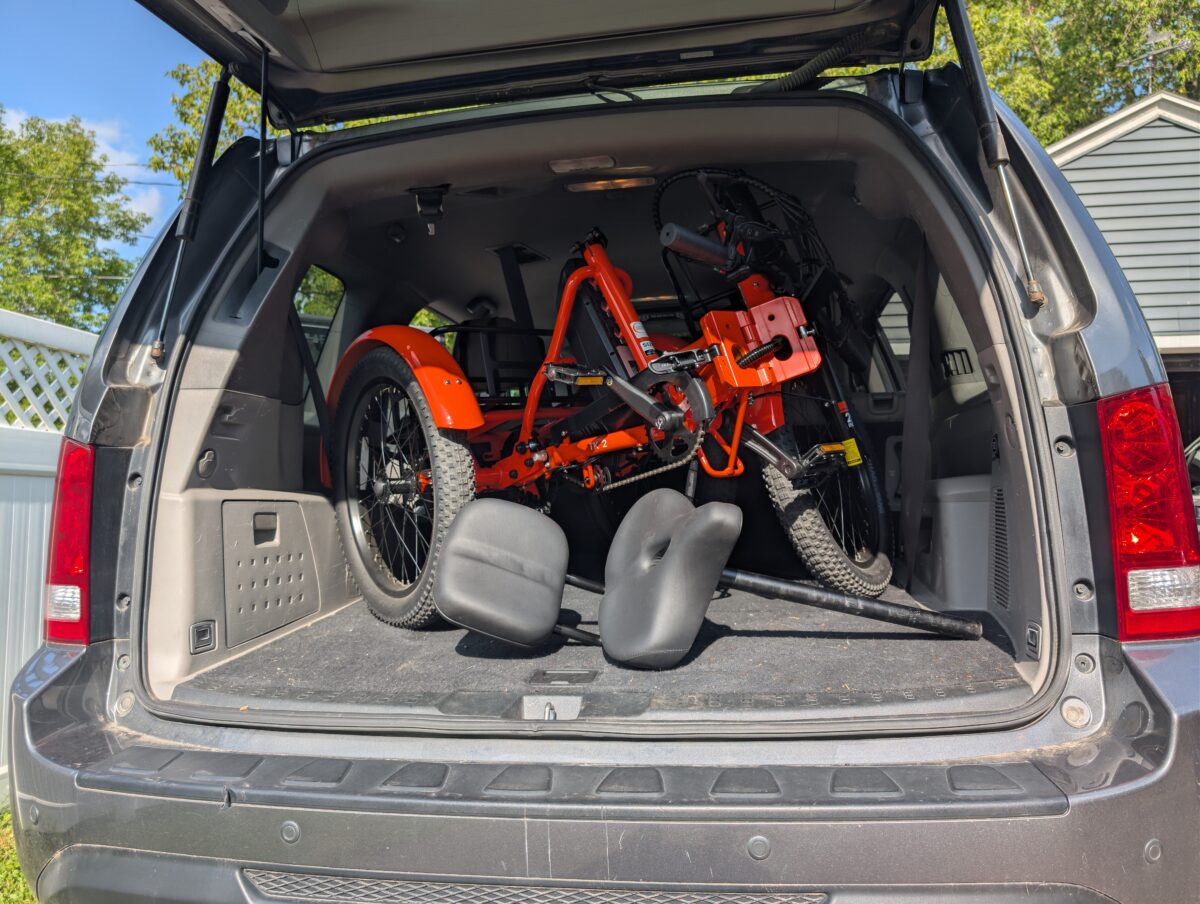 Mooncool TK2 folded and loaded in the cargo area of an SUV