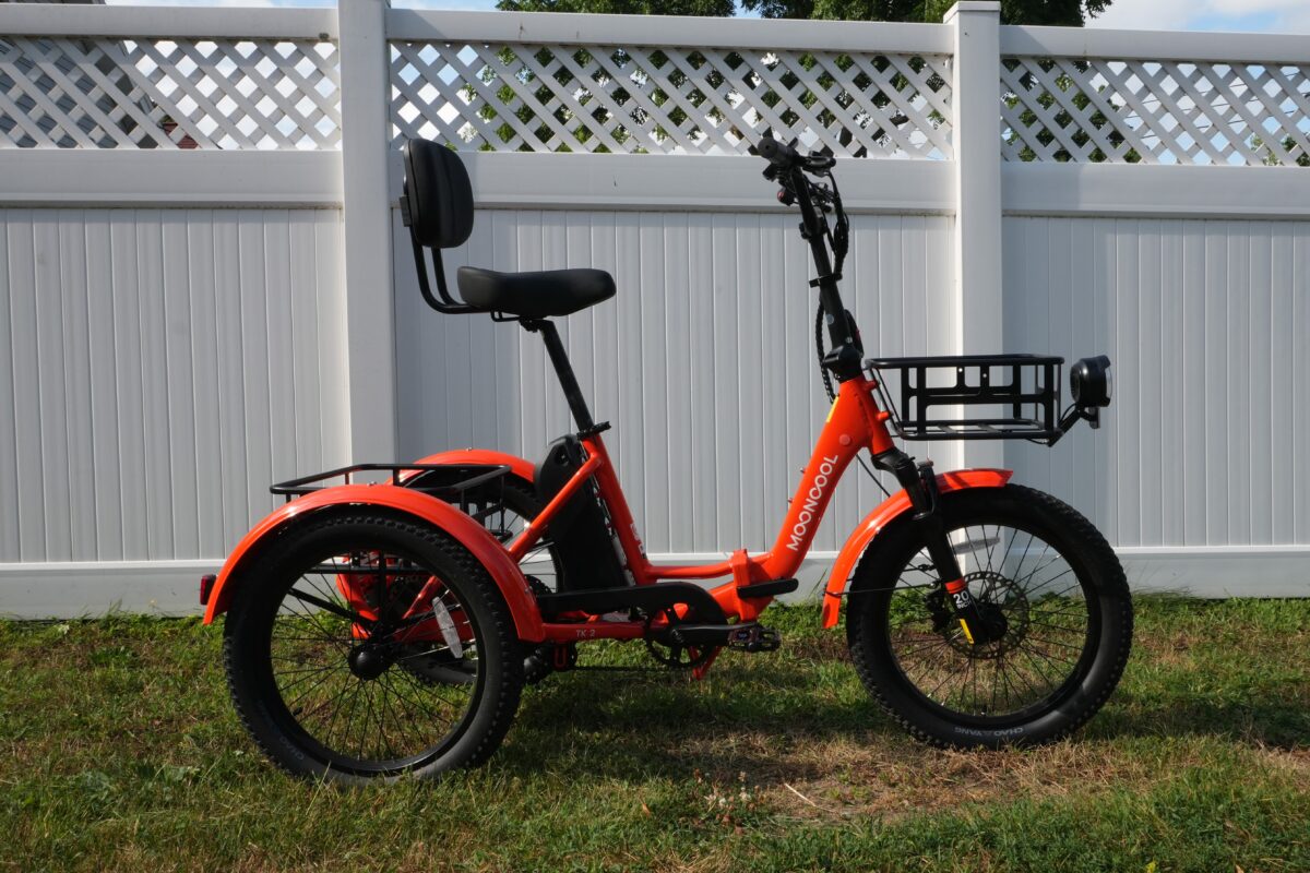 Mooncool TK2 electric trike in vibrant orange, side view