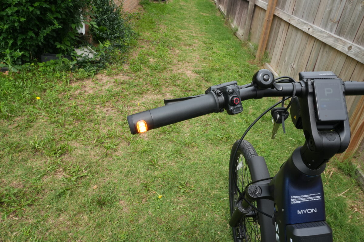 Turn signal built into the end of the right grip on the Segway Myon.