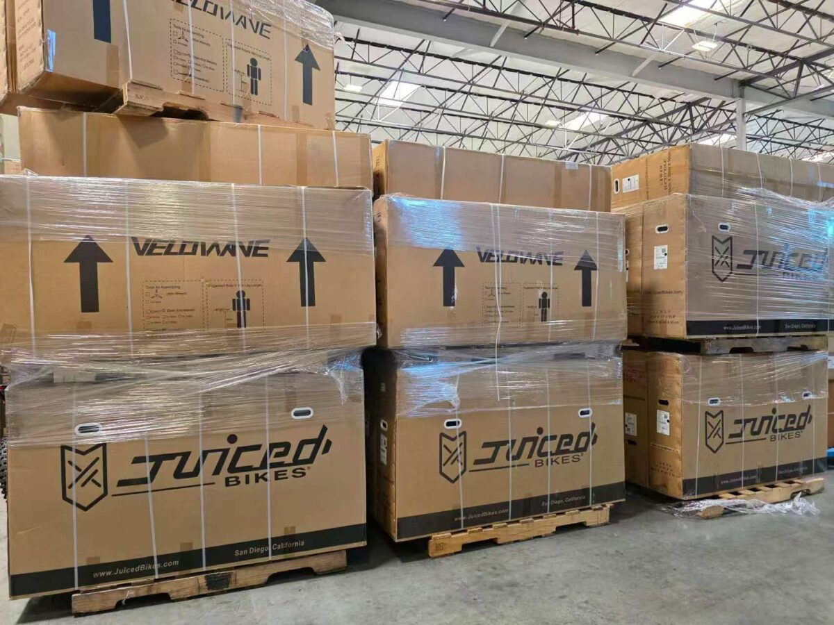 Pallets of boxed Juiced Bikes and Velowave ebikes stacked in Napune’s US warehouse