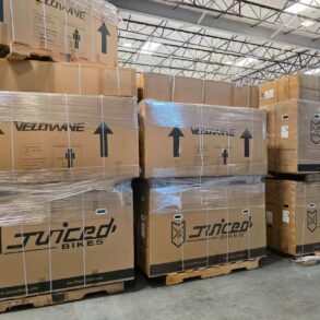 Pallets of boxed Juiced Bikes and Velowave ebikes stacked in Napune’s US warehouse