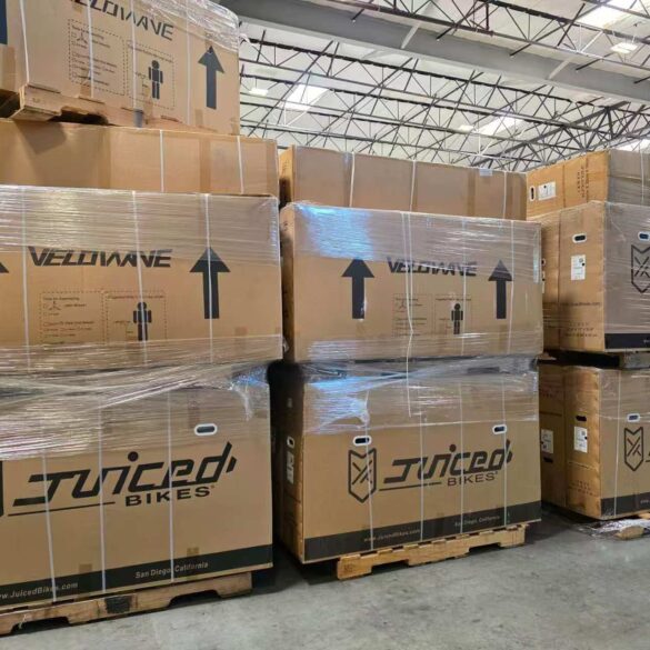Pallets of boxed Juiced Bikes and Velowave ebikes stacked in Napune’s US warehouse