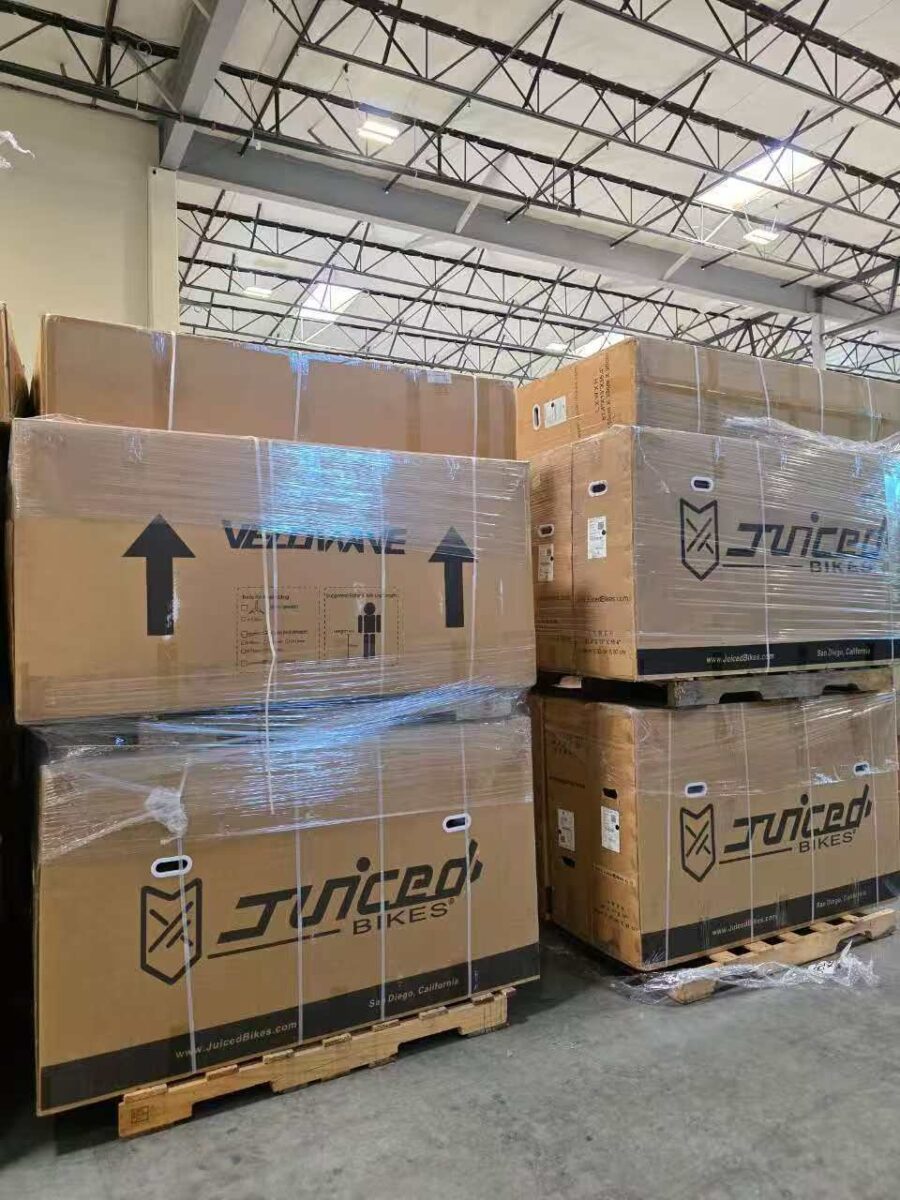 Shrink-wrapped Juiced Bikes boxes on pallets in Napune’s California warehouse